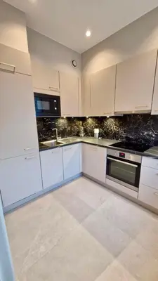 a white kitchen with white cabinets and appliances at Modern cozy flat close to Attractions & Transport in Brussels
