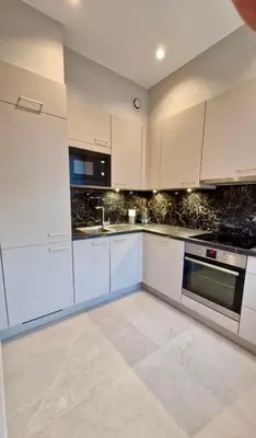 a white kitchen with white cabinets and appliances at Modern cozy flat close to Attractions & Transport in Brussels