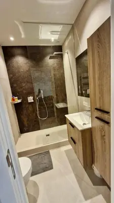 a bathroom with a shower and a toilet and a sink at Modern cozy flat close to Attractions & Transport in Brussels