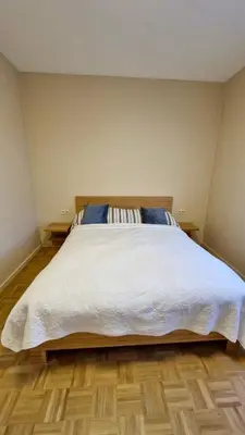 a bedroom with a large white bed with blue pillows at Modern cozy flat close to Attractions & Transport in Brussels
