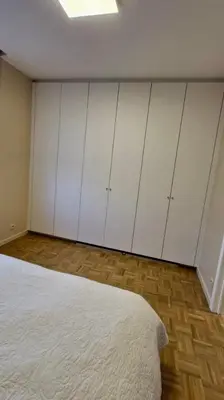a bedroom with white cabinets and a bed at Modern cozy flat close to Attractions & Transport in Brussels
