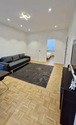 a large living room with a couch and a television at Modern cozy flat close to Attractions & Transport in Brussels