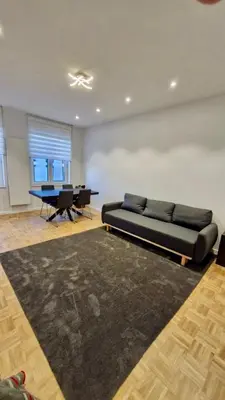 a living room with a couch and a table at Modern cozy flat close to Attractions & Transport in Brussels