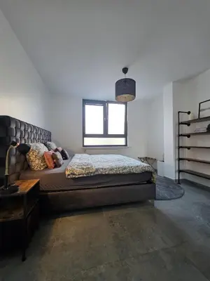 a bedroom with a large bed and a window at Nord center 1G in Brussels