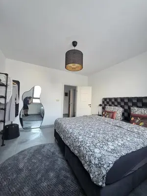 a bedroom with a large bed and a chair at Nord center 1G in Brussels