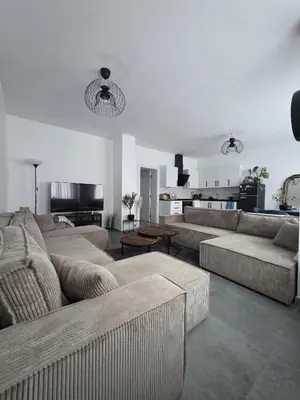 a living room with two couches and a kitchen at Nord center 1G in Brussels
