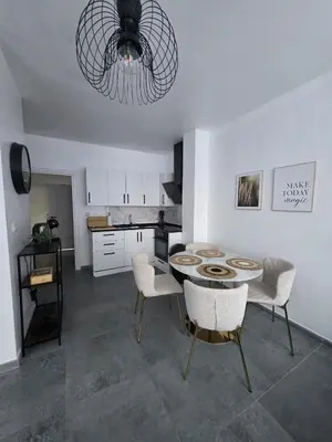 a kitchen with a table and chairs in a room at Nord Center 1D in Brussels