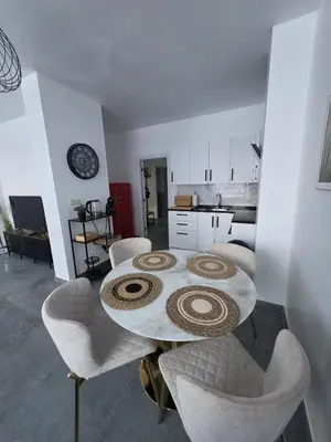 a dining room with a table and chairs in a kitchen at Nord Center 1D in Brussels