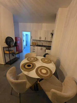 a table and chairs in a room with a kitchen at Nord Center 1D in Brussels