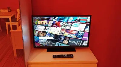 a flat screen tv sitting on top of a table at Charming studio apartment with terrace near Mérode in Brussels