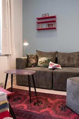 a living room with a couch and a table at Chaleureux appartement aux Marolles in Brussels