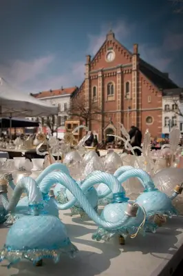 a group of glass figurines in front of a building at Chaleureux appartement aux Marolles in Brussels