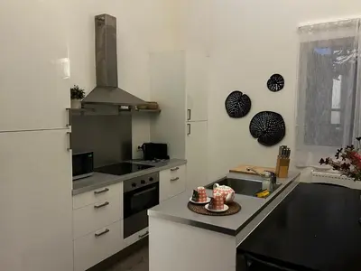 a kitchen with a white refrigerator and a counter top at 3 bedroom Loft Antwerp in Antwerp