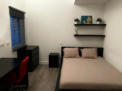 a bedroom with a bed and a desk and a chair at 3 bedroom Loft Antwerp in Antwerp