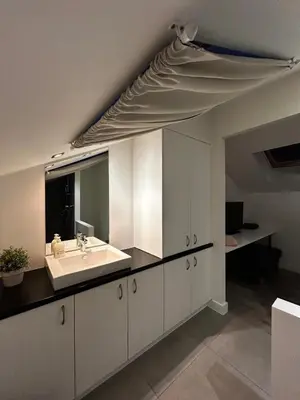 a bathroom with a sink and a large mirror at 3 bedroom Loft Antwerp in Antwerp