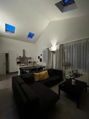 a living room with a couch and a table at 3 bedroom Loft Antwerp in Antwerp
