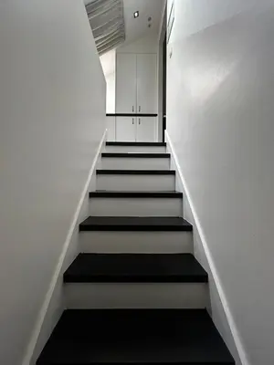 a stairway with white walls and a white stair case at 3 bedroom Loft Antwerp in Antwerp