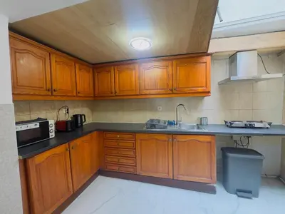 a kitchen with wooden cabinets and a sink at The Brussels Nest in Brussels