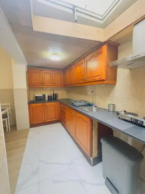 a kitchen with wooden cabinets and a counter top at The Brussels Nest in Brussels