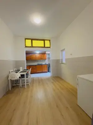 an empty room with a table and a kitchen at The Brussels Nest in Brussels