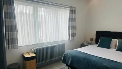 a bedroom with a bed and a large window at Villa-gey Escape in Bekkevoort
