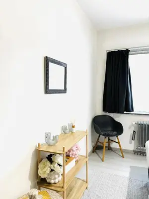 a living room with a table and a chair at Villa-gey Escape in Bekkevoort