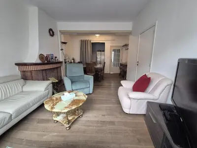 a living room with a couch and a coffee table at Large 1st floor apartment, Schaerbeek, Brussels in Brussels