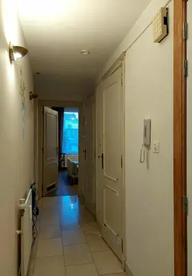 a hallway with a door and a room with a tile floor at Large 1st floor apartment, Schaerbeek, Brussels in Brussels