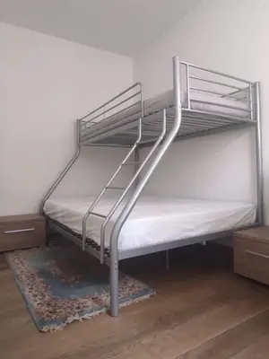 a bedroom with a bunk bed with a spiral staircase at Large 1st floor apartment, Schaerbeek, Brussels in Brussels