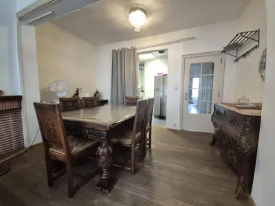 a dining room with a wooden table and chairs at Large 1st floor apartment, Schaerbeek, Brussels in Brussels