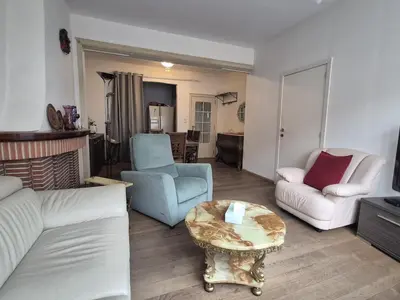 a living room with a couch and a table at Large 1st floor apartment, Schaerbeek, Brussels in Brussels