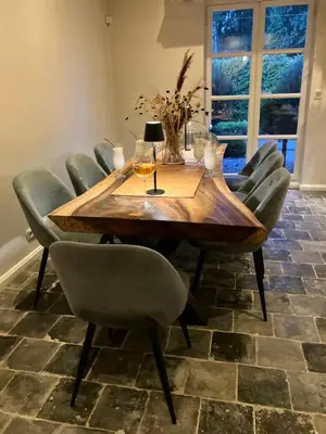 a dining room with a wooden table and chairs at The Oak & Squirrel Villa in Hoogstraten