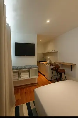 a living room with a television on a wall at Cozy and centrally located studio apartment in Brussels