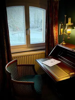 an office with a desk and a chair and window at Logies Het Koetshuis in Herentals