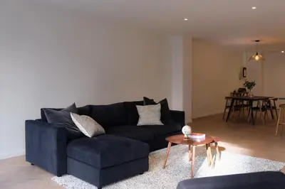 a living room with a blue couch and a table at Brussels center spacious and central apartment in Brussels