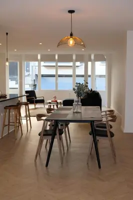 a living room with a table and chairs at Brussels center spacious and central apartment in Brussels