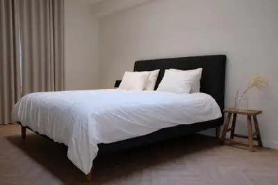 a bedroom with a large bed with white sheets and pillows at Brussels center spacious and central apartment in Brussels