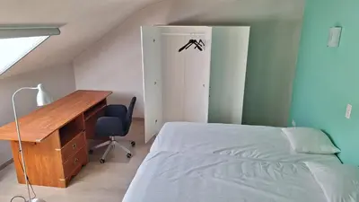 a bedroom with a desk and a bed and a desk and chair at Peaceful Countryside Escape for Leisure or Work, Near Brussels in Dilbeek