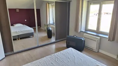 a room with a bed and a large mirror at Peaceful Countryside Escape for Leisure or Work, Near Brussels in Dilbeek