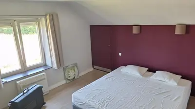 a bedroom with a white bed and a purple wall at Peaceful Countryside Escape for Leisure or Work, Near Brussels in Dilbeek