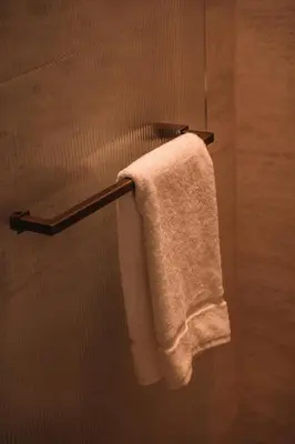 a towel hanging on a towel rack in a bathroom at SKIPR Hotel - adults only in Antwerp