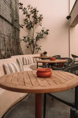 a wooden table with bowls on top of it at SKIPR Hotel - adults only in Antwerp