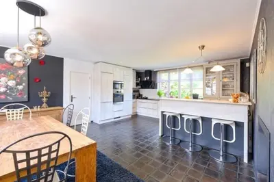 a kitchen with a table and a dining room at La Chanterelle in Wavre