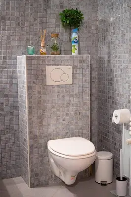 a bathroom with a toilet and a tiled wall at Studio in Brussels in Brussels
