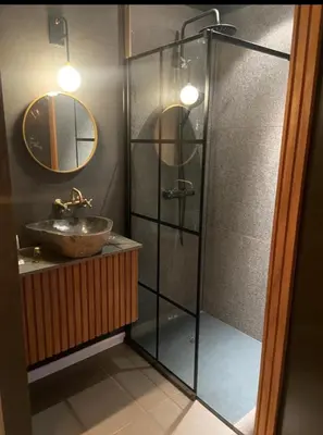 a bathroom with a sink and a glass shower at Dtoxx Waasmunster in Waasmunster