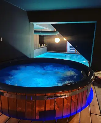 a large hot tub with blue water in a room at Dtoxx Waasmunster in Waasmunster
