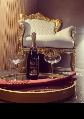 a bottle of champagne and two glasses on a table at Dtoxx Waasmunster in Waasmunster
