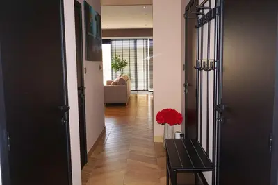 a hallway with a bench and a vase of red flowers at B&B by Delizia met mogelijkheid tot bijhuren van privé wellness in Rumst