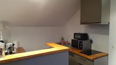 a kitchen with a counter top with a microwave at Guesthouse Biolleke in Boutersem