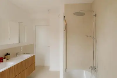 a bathroom with a shower and two sinks at Boutique Guesthouse - Private Top floor - 3 rooms - host on site available in Ghent